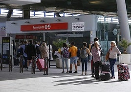 Passengers wait outside the local train station at Malaga Airport.