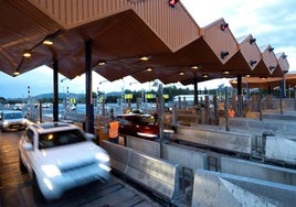 Vehicles passing through a motorway toll area.