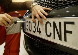 Fitting a car registration number plate.