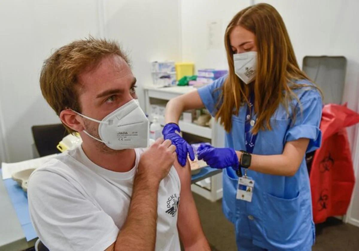 File image of a young man being vaccinated against flu at a health centre in Spain.