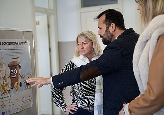 Olea looks at one of the posters of the information campaign.