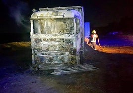 The wrecked lorry after the flames were extinguished.