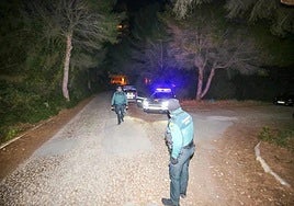 A Guardia Civil patrol stops all traffic on a road near the scene of the murder of three men in El Saler.