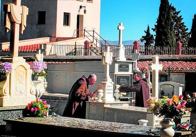 Brothers clean the cemetery.