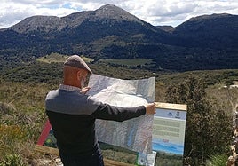 Rafael Flores studies the brand new map at one of the viewpoints in this national park.
