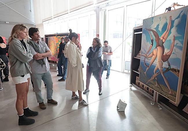 Visitors looking at Pedro Hoz's work.