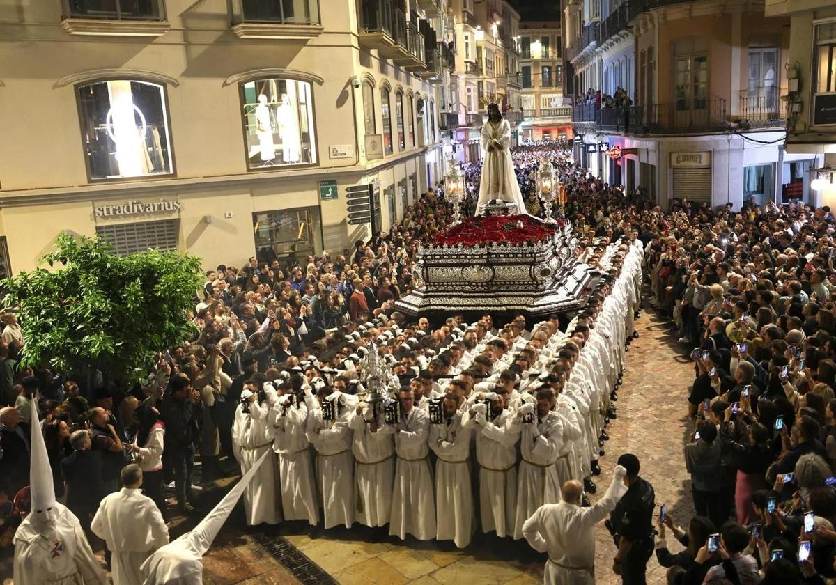 How much money do the spectacular Semana Santa processions bring into Malaga?