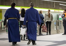 Cofrades inside the Guadalmedina station of the Malaga metro.