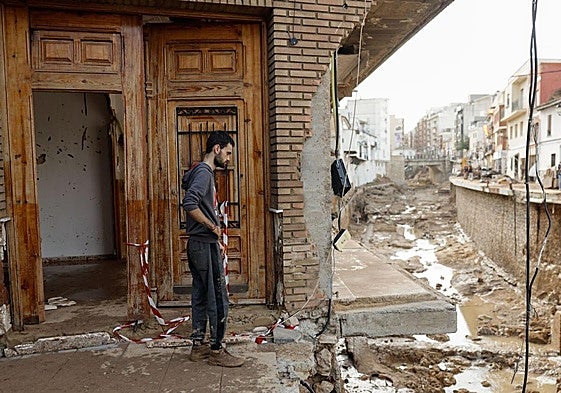 A man looks on at the aftermath of the flash flood in Chiva