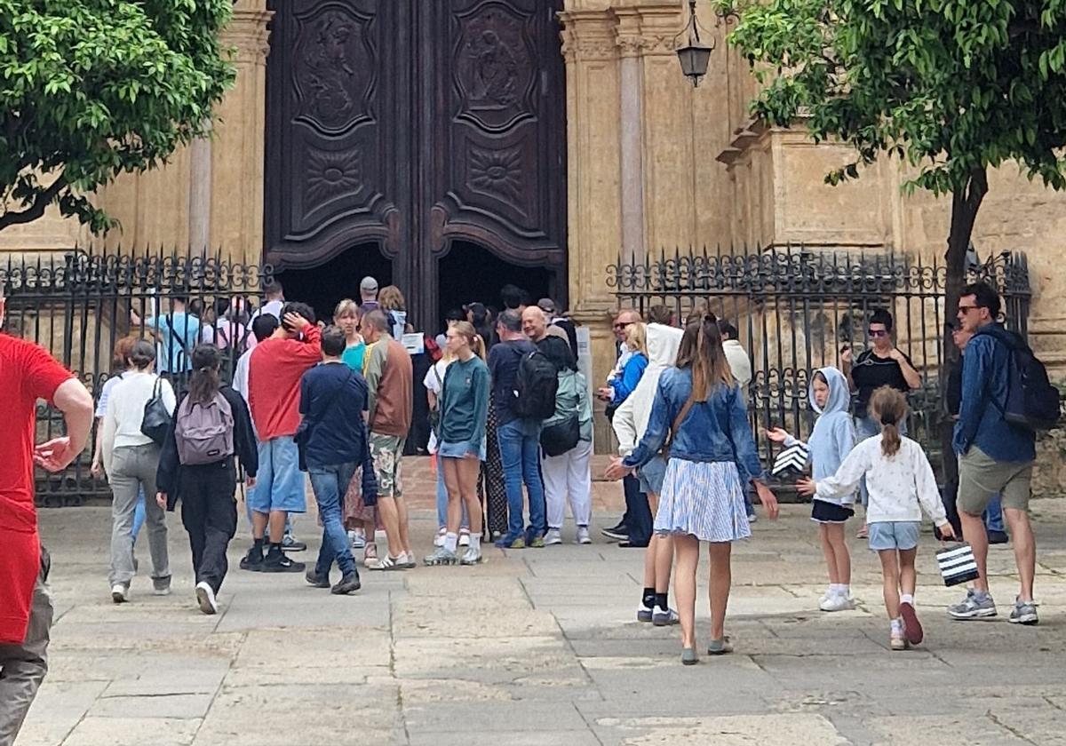Tourists at one of the entrances to Malaga Cathedral this Easter.