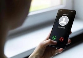 A person receives a spam call.