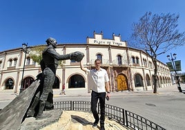 Marc Skarman, current owner of the bullring in Fuengirola, poses next to the sculpture of the bullfighter Antonio José Galán, located outside the bullring.