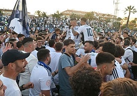 Marbella fans on the pitch after the full-time whistle to celebrate survival.