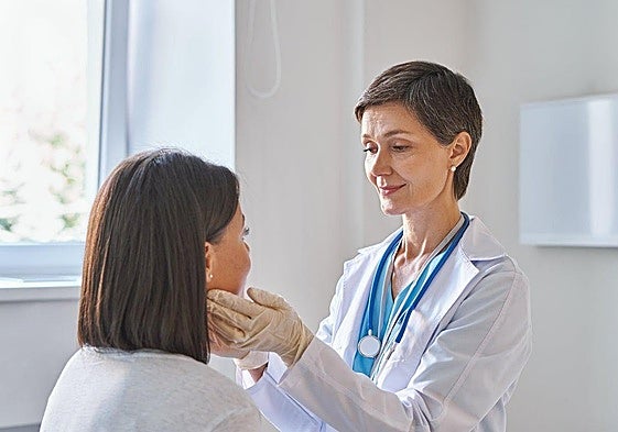 A GP checks a patient's health.