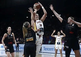Spain's Raquel Carrera shoots under pressure from Julie Vanloo.