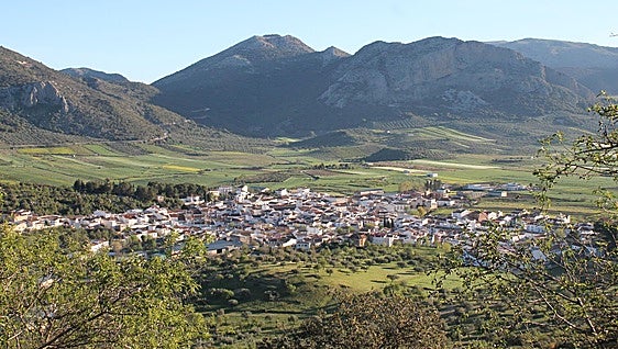 Why do some residents of Malaga towns and villages refer to them as 'The Place'