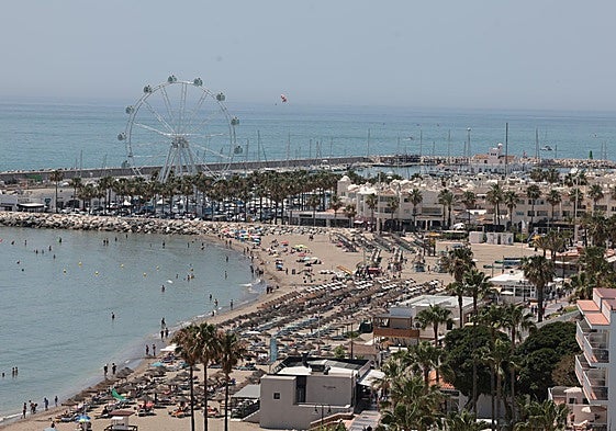 Photo of the Malaga coastline, with Puerto Marina in the background.