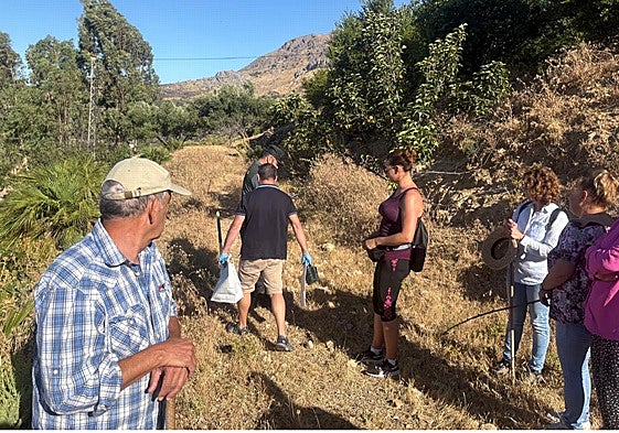 Guardia Civil officers with the weapon used in the alleged attack in a bag, after it was located on the farm.