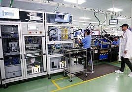 Workers at the Denso Ten technology company's factory in Malaga.