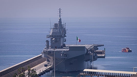 Why is one of the largest warships in the Italian navy docked in Malaga port?