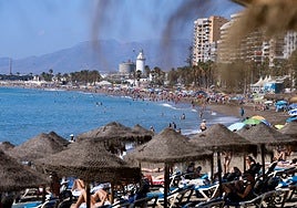 Tourists and locals enjoying beach time in Malaga city.