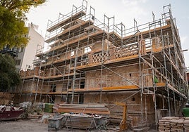 The roof tiling and the building's exterior coatings have been removed.