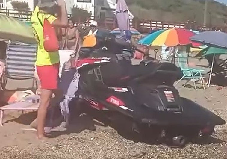 The jet ski, stranded on the sand after shooting out of the water.