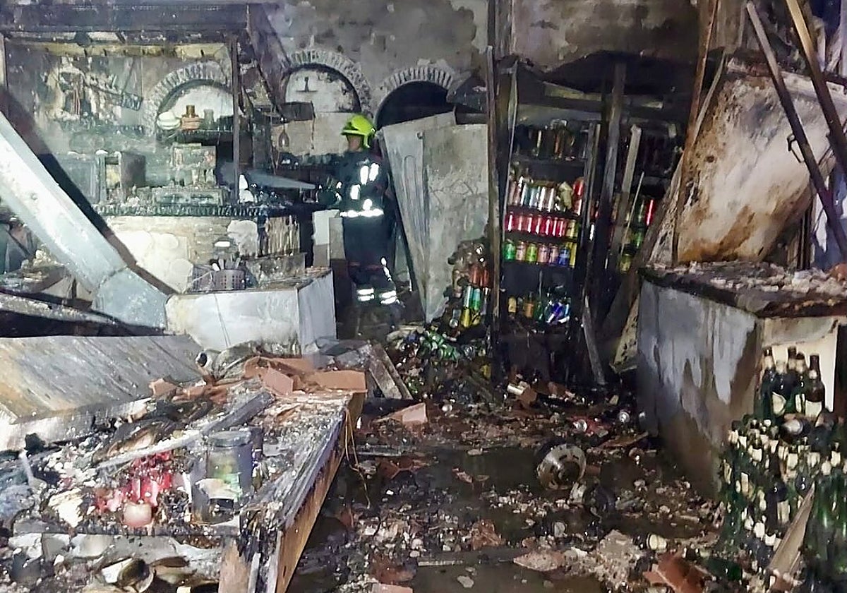Police forensic experts investigate what sparked fire that severely damaged seven pubs on the Costa del Sol