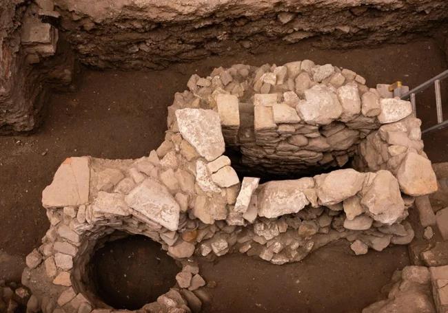 A bird's-eye view of two wells, with the rectangular, waterwheel-like well on the right being particularly striking.