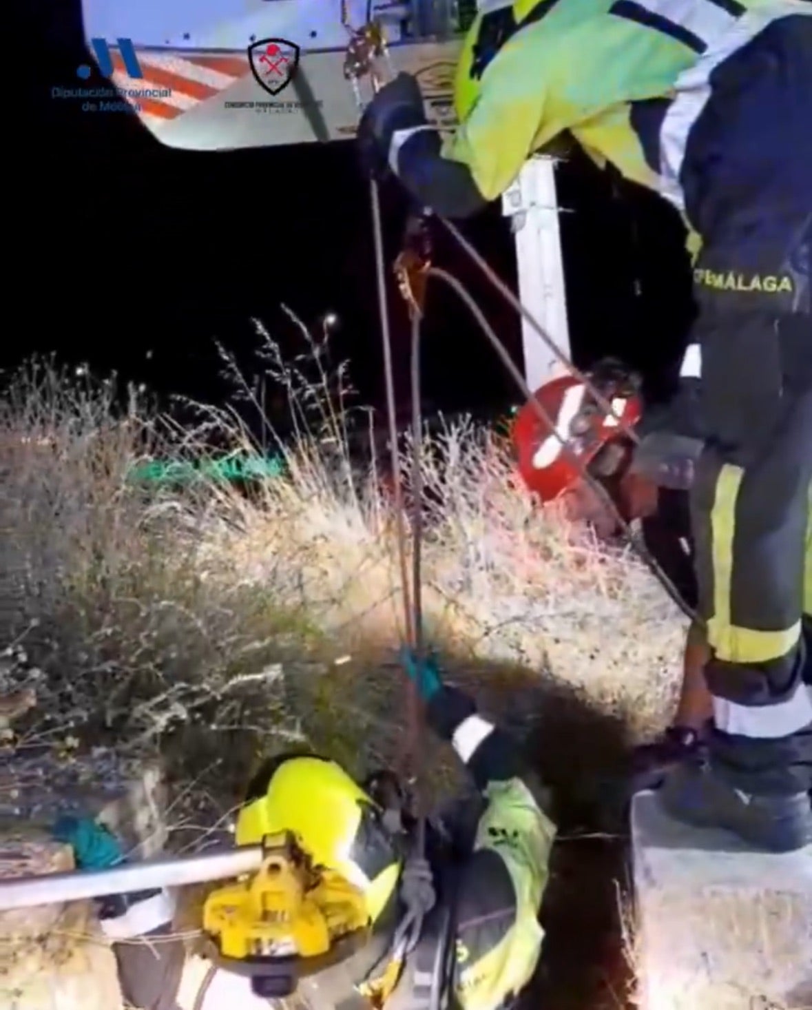 Firefighters at the well where David Ruiz's body was found.