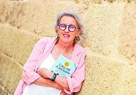 Laurie Levin posing with her book Call Me a Woman about the benefits of gender equality for world peace.