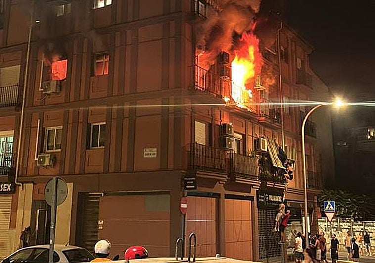 Residents leave the building by climbing down from a balcony.