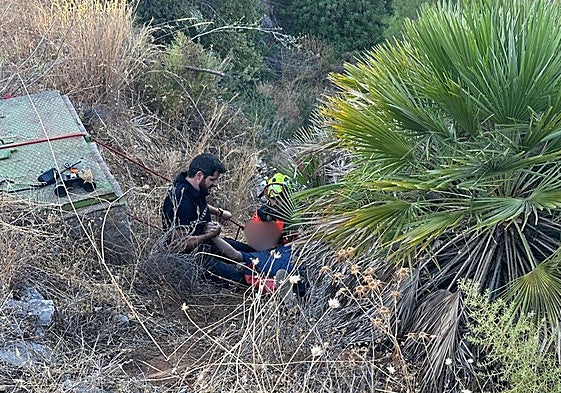 A local policeman grabs the injured man.
