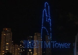 The silhouette of the future TM Tower skyscraper, drawn at night by drones in Benidorm.