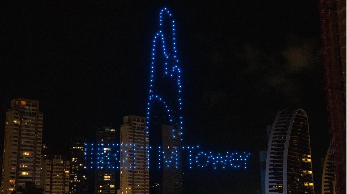 The silhouette of the future TM Tower skyscraper, drawn at night by drones in Benidorm.