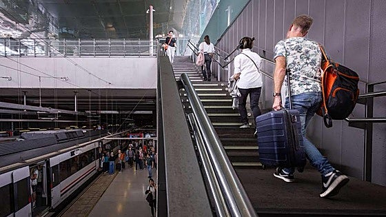 Why have the four escalators at Malaga Airport train station been out of service for several months now?