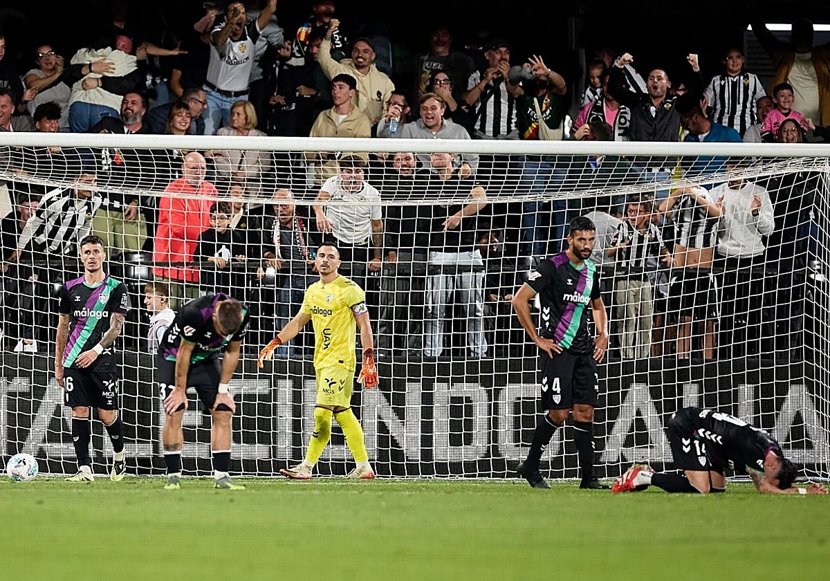 The devastated Malaga players after conceding the late goal.