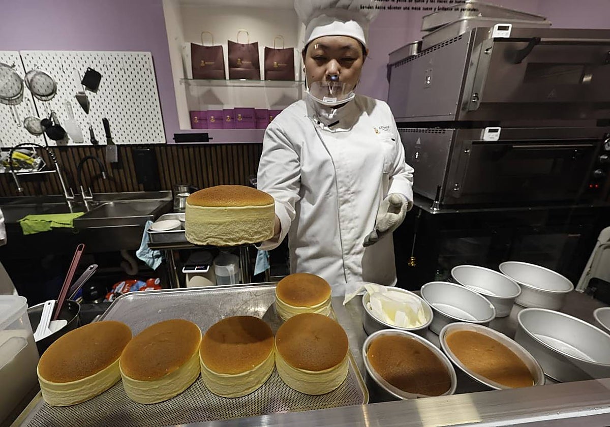 Yeouxiang Wang takes out one of the first batches of cakes before preparing them to take away.