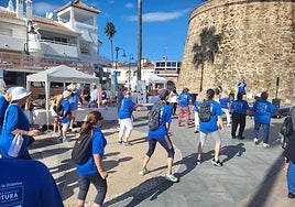 Participants doing the warm-up exercises before the walk.