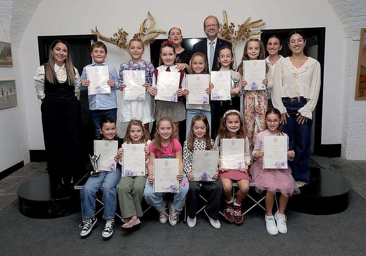 Some of the dance students with their awards with education minister John Cortes at the back.