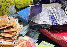Archive image of cash and condoms seized in a police operation against sexual exploitation.