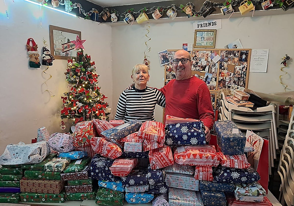 Carol Baxter and Claudio Castellon with gifts collected during last year's appeal.