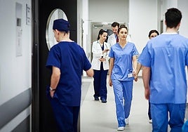 Doctors walking down a hospital corridor.