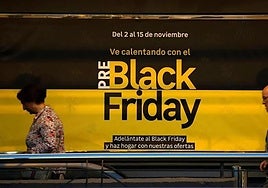 A woman walks past an advertisement in the days leading up to Black Friday in Bilbao.