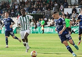 Marbella's Álex Martínez pushes forward with the ball.