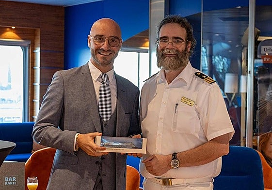 Christian Santos with the ship's captain Frederick Boris Becker.