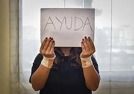 A young woman recovering from a suicide attempt and raising awareness with a 'help' placard.