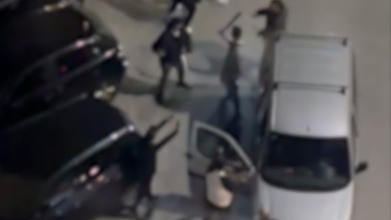 Residents take cover as youths armed with axes, curved swords and metal chains clash in Malaga neighbourhood