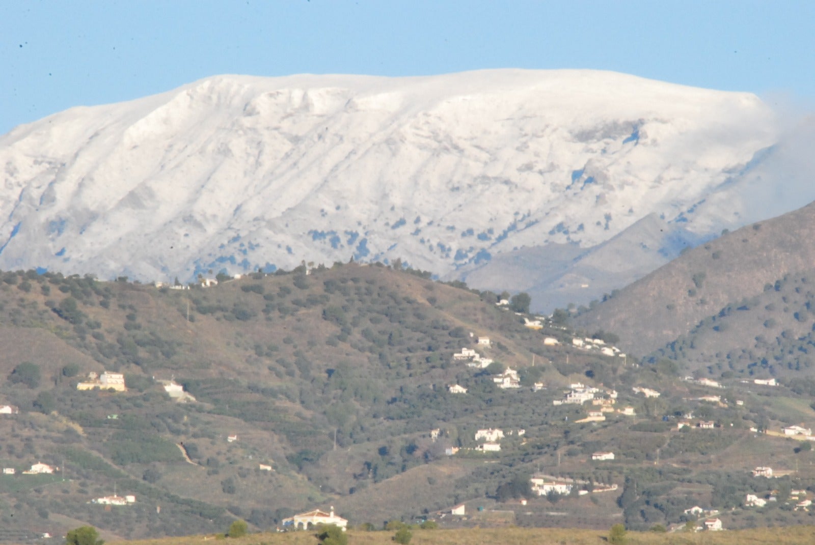 La Maroma mountain covered in white, seen from Nerja.