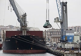 Unloading of bulk cargo on a ship in the port of Malaga.